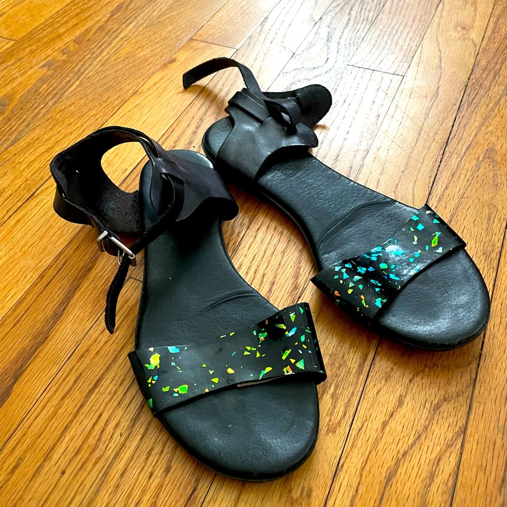 Black leather with metallic sparkles in the toe strap. Size 36= US size 6